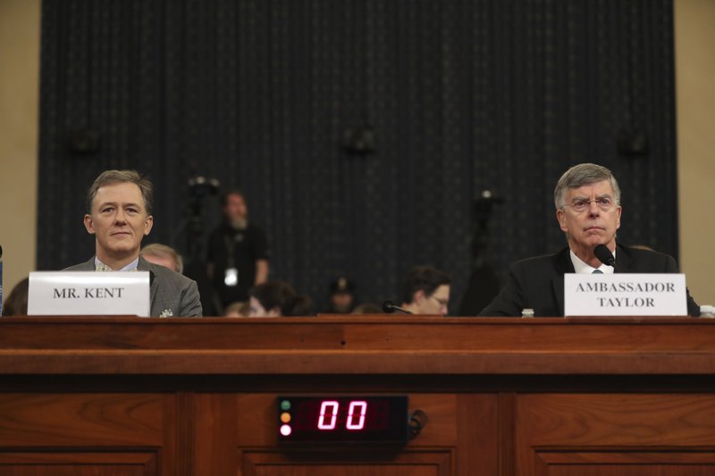 Top U.S. diplomat in Ukraine William Taylor, right, and career Foreign Service officer George Kent, take their seats as they arrive to testify before the House Intelligence Committee on Capitol Hill in Washington, Wednesday, Nov. 13, 2019, during the first public impeachment hearing of President Donald Trump's efforts to tie U.S. aid for Ukraine to investigations of his political opponents. (AP Photo/Andrew Harnik)

