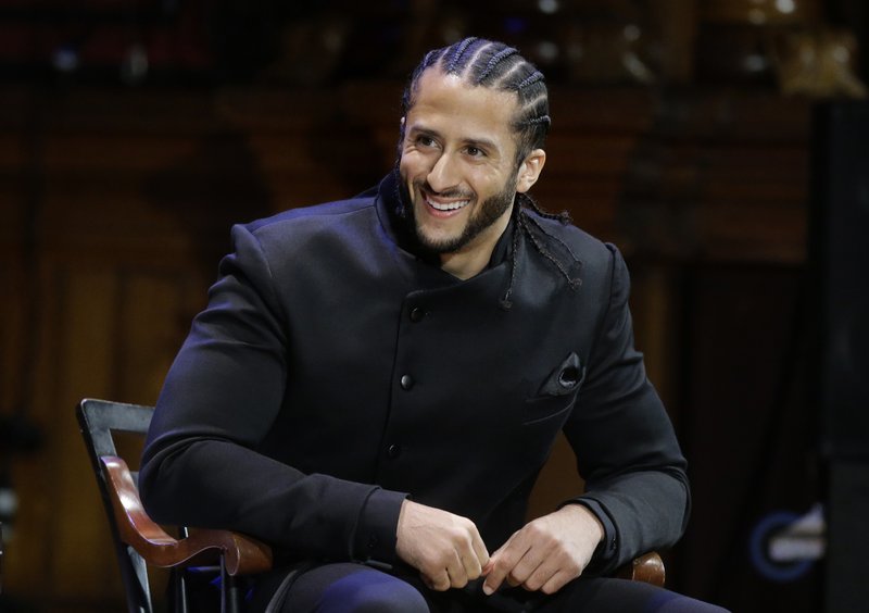 FILE - In this Oct. 11, 2018, file photo, former NFL football quarterback Colin Kaepernick smiles on stage during W.E.B. Du Bois Medal ceremonies at Harvard University, in Cambridge, Mass. Kaepernick plans to audition for NFL teams on Saturday, Nov. 16, 2019, in a private workout arranged by the league to be held in Atlanta. (AP Photo/Steven Senne, File)