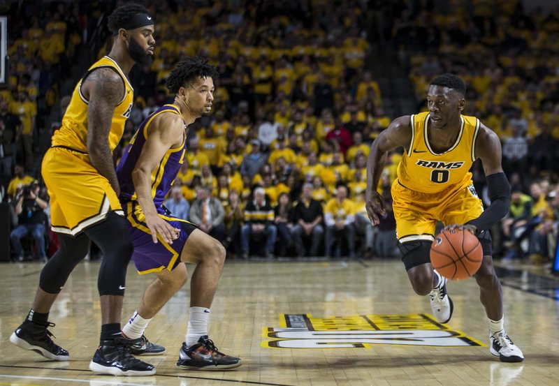 Virginia Commonwealth guard De'Riante Jenkins (0) drives around LSU guard Skylar Mays (4) during the first half of an NCAA college basketball game in Richmond, Va., Wednesday, Nov. 13, 2019. (AP Photo/Zach Gibson)