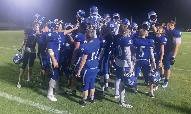 Caleb Slinkard/News-Times Parkers Chapel meets on the field after beating Glenbrook Academy (La.) earlier this season at Victor Nipper Stadium. Tonight, the Trojans host Poyen in the first round of the 2A playoffs.