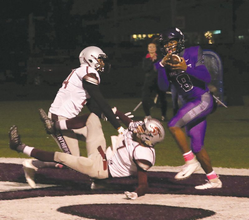 Siandhara Bonnet/News-Times El Dorado's Jackie Washington lands in the end zone after catching a pass from Eli Shepherd during the Wildcats' game against Siloam Springs last month at Memorial Stadium. El Dorado travels to Jonesboro to start the 6A playoffs. Game time is set for 7 p.m.