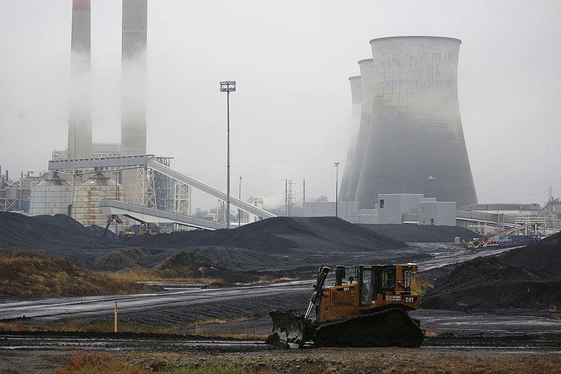A bulldozer drives past the Tennessee Valley Authority’s Paradise plant in Paradise, Ky., which used  to burn coal mined by the now-bankrupt Murray Energy Holdings. 