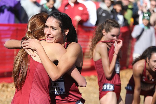 Arkansas' Taylor Werner (facing) hugs teammates after crossing the finish line during the NCAA South Regional on Friday, Nov. 15, 2019, at Agri Park in Fayetteville.