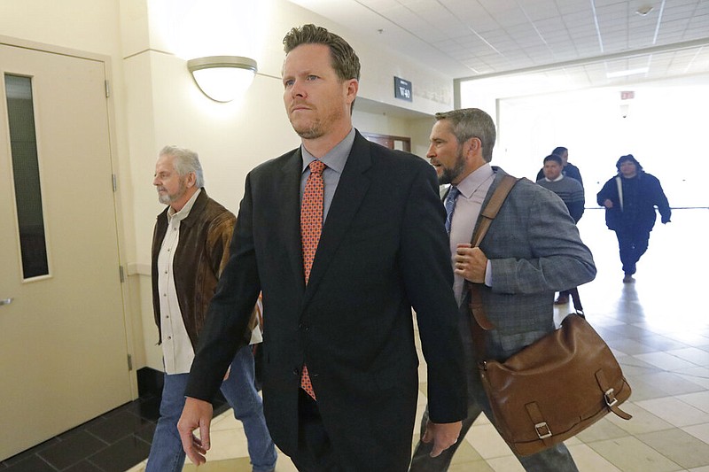 Paul Petersen, an Arizona elected official accused of running a multi-state adoption scheme, arrives at court for an initial appearance on charges filed in the state Friday, Nov. 15, 2019, in Salt Lake City. Prosecutors in three states say Petersen brought pregnant women from the Marshall Islands to the United States and paid them to give up their babies for adoption. He's pleaded not guilty. (AP Photo/Rick Bowmer)