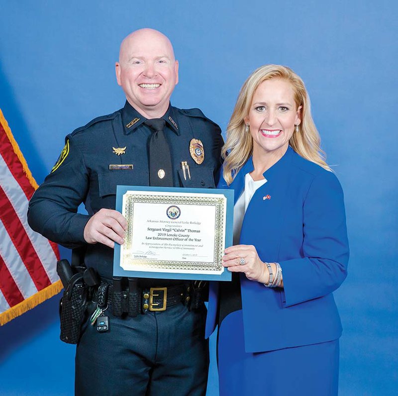 Sgt. Virgil “Calvin” Thomas of the Cabot Police Department receives the 2019 Lonoke County Law Enforcement Officer of the Year award from Arkansas Attorney General Leslie Rutledge. Thomas has worked for the department since 2005.