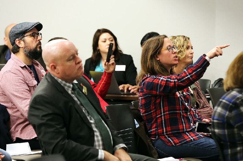Veronica McClane (left) shouts “Shame!” during the state Board of Education meeting Friday as she and others protested the board’s refusal to take comments before voting to expand the Little Rock School District personnel policy panel to more than 40 members.