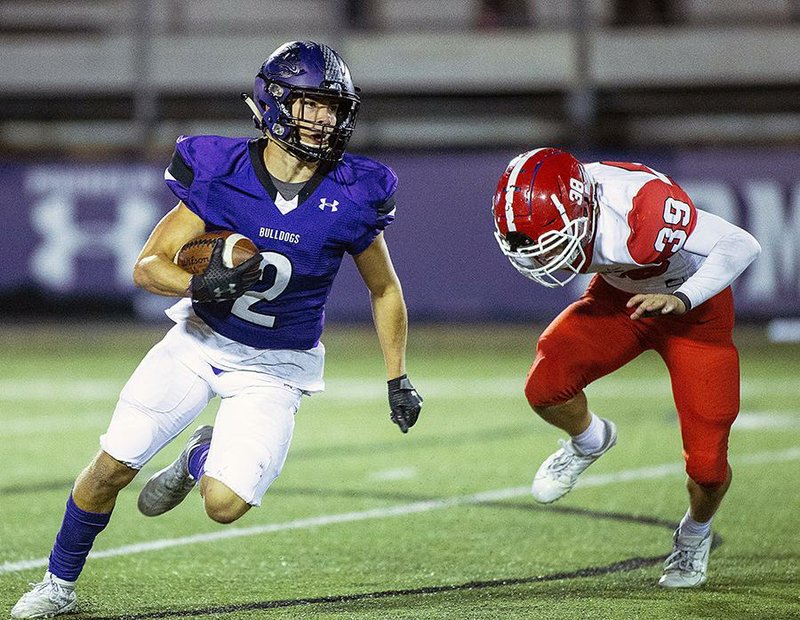 Fayetteville’s Connor Flannigan (left) runs away from Cabot’s Masen Wade during Friday’s Class 7A playoff game at Harmon Stadium in Fayetteville. Fayetteville won 44-14. More photos are available at arkansasonline.com/1116cabot/