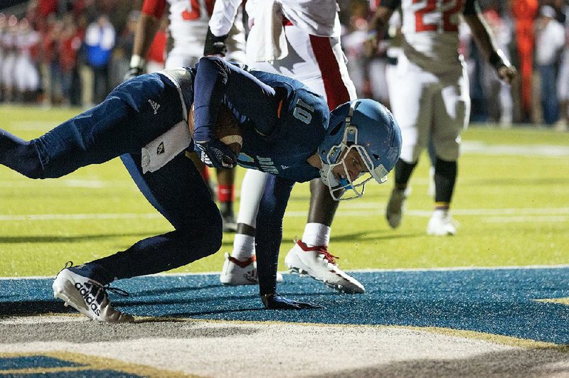 Pulaski Academy wide receiver Andrew Cobb tries to stay on his feet after scoring a touchdown Friday during the Bruins’ 63-34 victory over Magnolia. More photos are available at arkansasonline.com/1116magnoliapa.