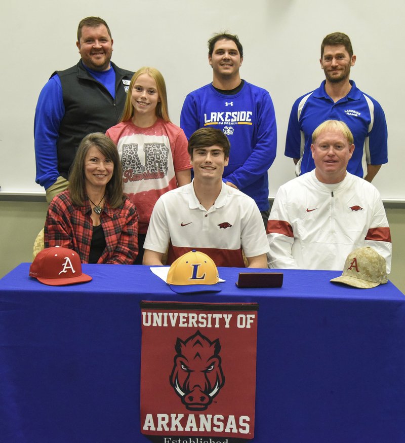 Lakeside senior Ethan Bates, front, center, signed his letter of intent to play baseball at the University of Arkansas in a ceremony at Lakeside's media center Wednesday. He was joined by Lakeside High School principal Darin Landry, back, left, Emilee Bates, assistant coach Garrett Bock, head coach Leighton Hardin, Robin Bates, front, left, and Rodger Bates, right. - Photo by Grace Brown of The Sentinel-Record