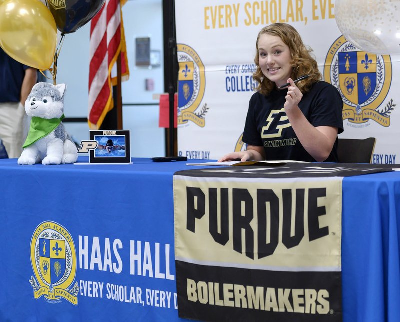 NWA Democrat-Gazette/SPENCER TIREY Haas Hall-Bentonville swimmer Hayley Pike holds up a pen just before become the first Haas Hall-Bentonville athlete to sign a national letter of intent as she signs with Purdue University.