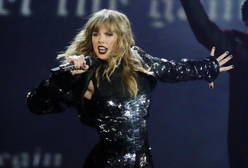 FILE - This May 8, 2018 file photo shows Taylor Swift performing during her &quot;Reputation Stadium Tour&quot; opener in Glendale, Ariz. Swift says she may not be performing at the American Music Awards because the men who own her old recordings won&#x2019;t allow her to play her songs. Swift said on Instagram Thursday that she planned to play a medley of her hits when she&#x2019;s named Artist of the Decade at the American Music Awards on Nov. 24. But Swift says the men who own the music, Scooter Braun and Scott Borchetta, are calling the performance an illegal re-recording. (Photo by Rick Scuteri/Invision/AP, File)
