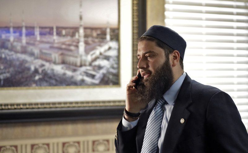 FILE - In this Feb. 20, 2019, file photo, Hassan Shibly, attorney for Hoda Muthana, the Alabama woman who left home to join the Islamic State group in Syria, speaks on a phone before a news conference in Tampa, Fla. A federal judge has ruled the U.S. government was correct when it determined Muthana, who joined the Islamic State, was not an American citizen despite her birth in the country. A family lawyer said Friday, Nov. 15, that they plan to appeal the ruling. (AP Photo/Chris O'Meara, file)