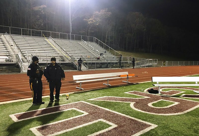 Police investigate the scene after a gunman shot into a crowd of people during a football game at Pleasantville High School in Pleasantville, N.J., Friday, Nov. 15, 2019.