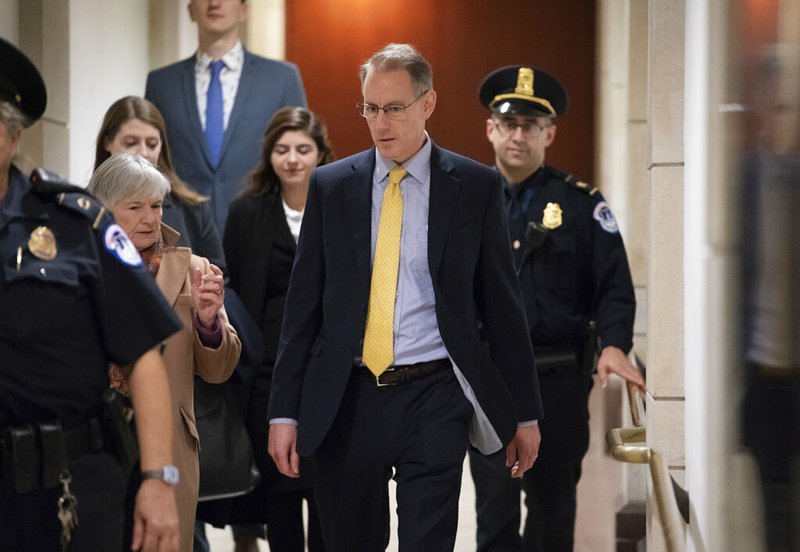 Mark Sandy, a career employee in the White House Office of Management and Budget, arrives at the Capitol to testify in the House Democrats' impeachment inquiry about President Donald Trump's effort to tie military aid for Ukraine to investigations of his political opponents, in Washington, Saturday, Nov. 16, 2019. 