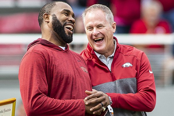 Arkansas athletics director Hunter Yurachek (right) laughs with former Arkansas running back Darren McFadden during a timeout of a game between the Razorbacks and Auburn on Saturday, Oct. 19, 2019, in Fayetteville. A federal lawsuit McFadden filed was recently dismissed without a public explanation.