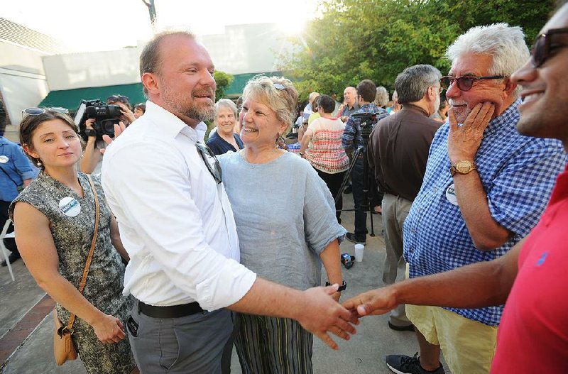 In this  Friday, July 26, 2019 file photo Josh Mahony (left), former candidate for the Democratic nomination for U.S. Senate, shakes hands with supporters, alongside Denise Garner, State Representative for Arkansas House District 84, during a press conference at the Fayetteville Town Center in Fayetteville. 