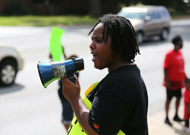 Ely Frankley encourages protesters to chant during a tenants rally in September outside the Spanish Valley Apartments in Little Rock. On Thursday night, Frankley was served with an eviction lawsuit.