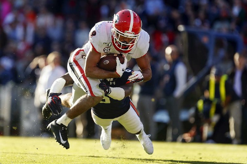 Georgia wide receiver Dominick Blaylock dives into the end zone for a score as Auburn’s Christian Tutt defends during the first half Saturday in Auburn, Ala. The Bulldogs won 21-14. 