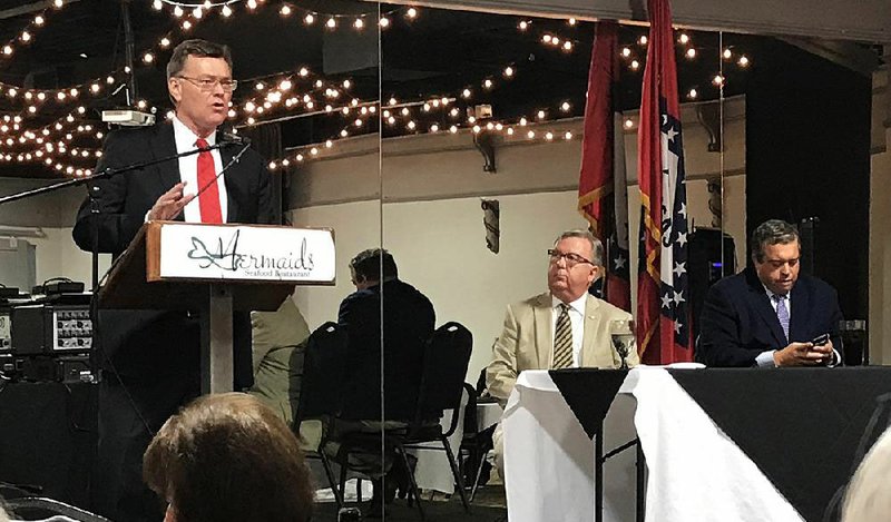 Circuit Judge John Threet (left) introduces Doyle Webb (center), Arkansas Republican Party chairman, and Michael John Gray, Arkansas Democratic Party chairman, during Friday’s meeting of the Political Animals Club in Fayetteville. 