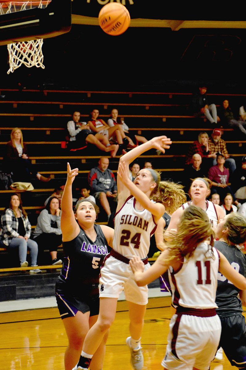 Mark Humphrey/Washington County Enterprise-Leader Siloam Springs junior Sydney Moorman gets off a shot in the lane while drawing a foul against Lavaca senior Amaya Mendez. The Lady Panthers knocked off Lavaca, 45-41, Thursday at West Fork's Duel at the Dome girls basketball tournament. The victory advanced Siloam Springs into the tournament finals Saturday against Farmington.