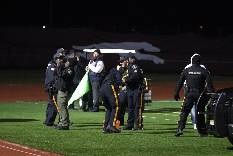 Police investigate the scene after a gunman shot into a crowd of people during a football game Friday at Pleasantville High School in Pleasantville, N.J. - Photo by The Associated Press