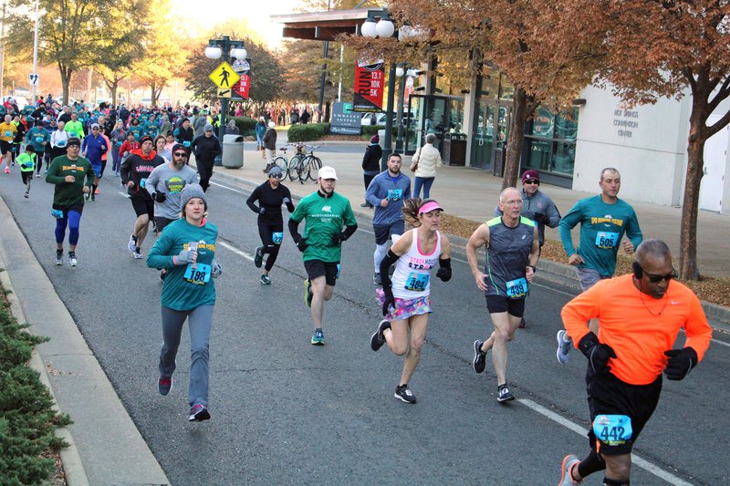 Runners in the annual Spa Running Festival 5K make their way down Convention Boulevard past the Hot Springs Convention Center on Saturday morning. - Photo by Tanner Newton of The Sentinel-Record