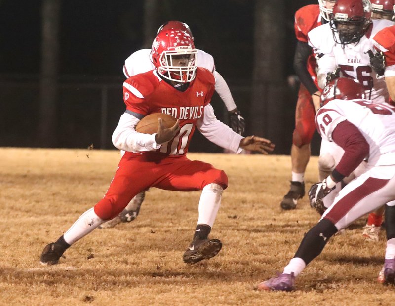 Mountain Pine's Jeremiah Walker (30) runs the ball against Earle at Stanley May Field Friday. The Red Devils finished their season with a record of 6-5 after the 16-14 loss in the first round of the Class 2A state football playoffs. - Photo by Richard Rasmussen of The Sentinel-Record