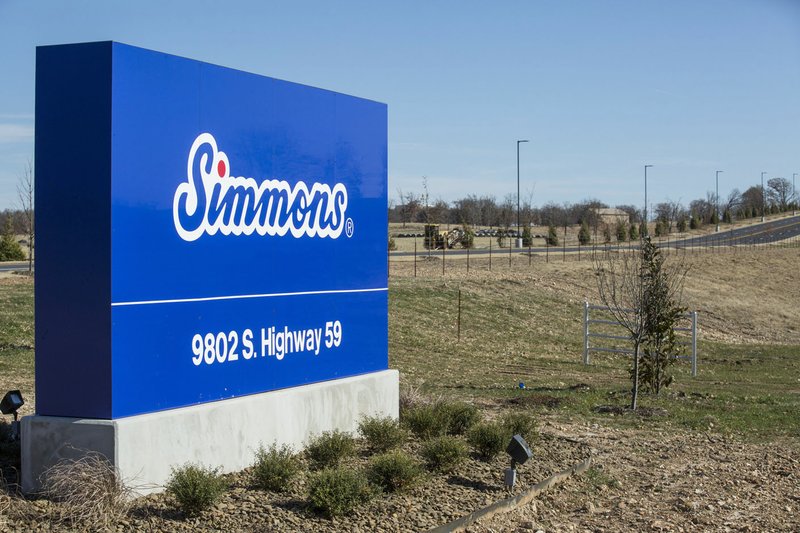 A sign for the new Simmons plant stands Wednesday along Arkansas 59 near Gentry. The plant is designed to harvest live chickens from around 300 independent family farmers to produce fresh and frozen chicken products, said Donny Epp, Simmons senior director of communications.