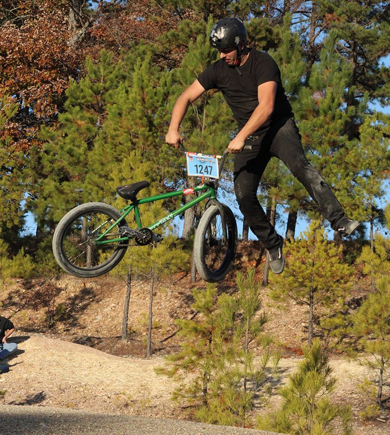 A rider shows his skills Saturday afternoon during the "Jump Jam" bike jump competition at the grand opening of the Northwoods Bike Park. - Photo by Jami Smith of The Sentinel-Record