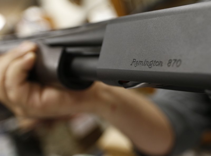 FILE - In this March 1, 2018 file photo, the Remington name is seen etched on a model 870 shotgun at Duke's Sport Shop in New Castle, Pa. For years, the gun industry has been immune from most lawsuits, but a recent ruling allowing families of victims in the Newton school shooting to challenge the way an AR-15 used by the shooter was marketed is upending that longstanding roadblock. The U.S. Supreme Court recently rejected efforts by gunmaker Remington to quash the lawsuit, allowing it to continue to be heard in Connecticut courts. (AP Photo/Keith Srakocic, File)