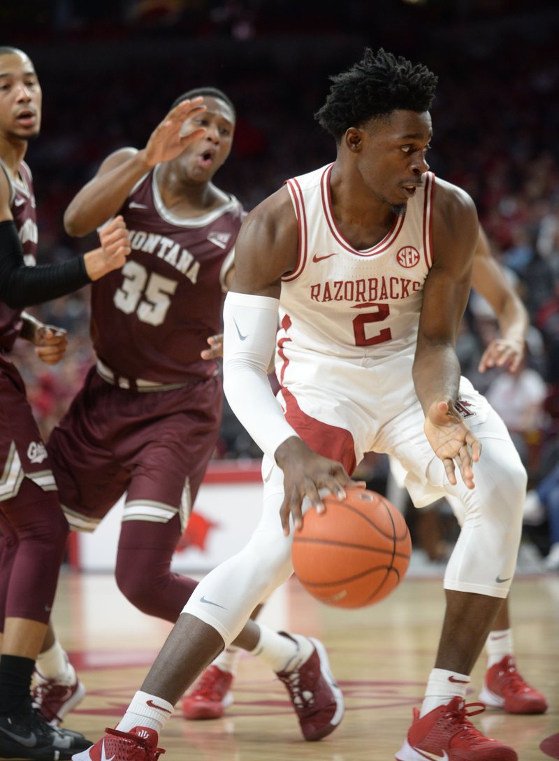 NWA Democrat-Gazette/Andy Shupe Arkansas forward Adrio Bailey (right) cuts to the basket past Montana Kendal Manuel (left) and Derrick Carter-Holilnger during the first half of play Saturday in Bud Walton Arena in Fayetteville. The Razorbacks won 64-46. See full game story at http://hotspringssr.com.