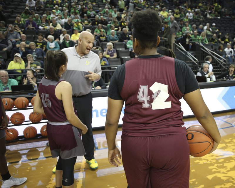 Oregon head coach Kelly Graves talks to Texas Southern players before Saturday's game in Eugene, Ore. Texas Southern's uniforms went missing, forcing them to improvise with practice jerseys and athletic tape. - Photo by Chris Pietsch of The Associated Press