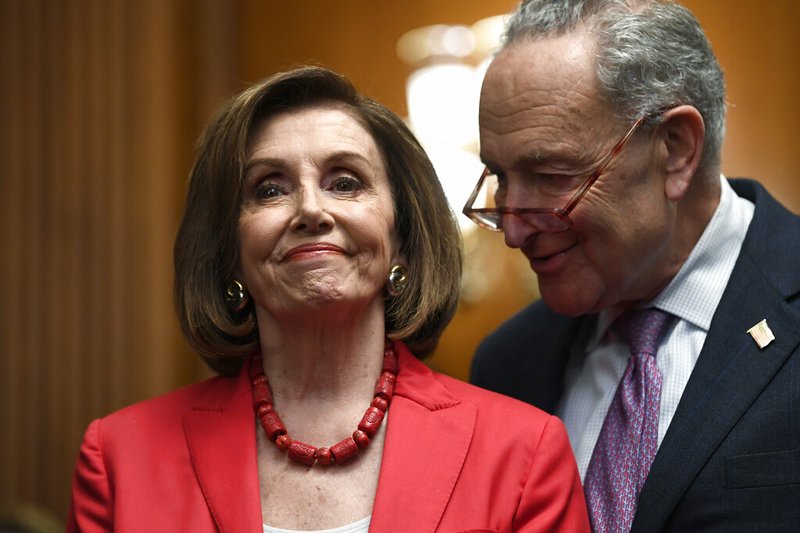 House Speaker Nancy Pelosi of Calif., left, and Senate Minority Leader Sen. Chuck Schumer of N.Y., right, listen as they wait to speak at an event on Capitol Hill in Washington, Tuesday, Nov. 12, 2019, regarding the earlier oral arguments before the Supreme Court in the case of President Trump's decision to end the Obama-era, Deferred Action for Childhood Arrivals program.

