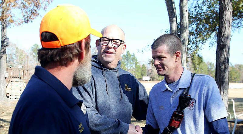 At the Little Rock Rugby Club on Saturday, Mark Owings (center) of Springfield, Mo., thanks Capt. Nick Medlock (left) and Fire Chief Cody Church with the Quail Creek Volunteer Fire Department. 