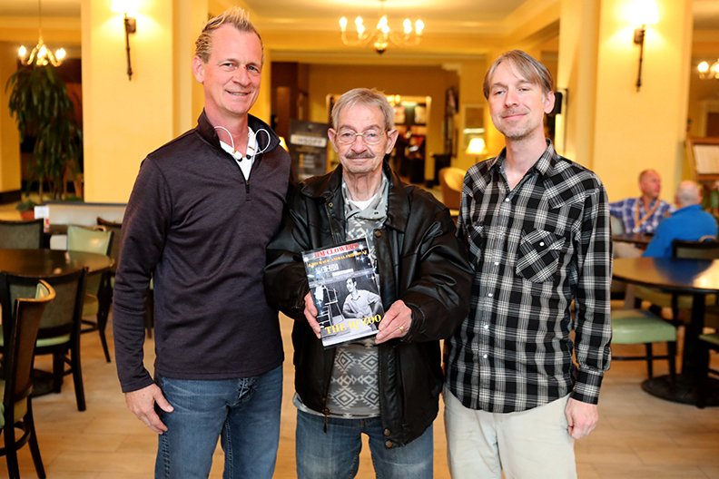 Jim Clowers, center, and his sons Jim Jr., left, and John display their new book that details the history of the elder Clowers and his work with animals during a stop at the Arlington Resort Hotel &amp; Spa. - Photo by Richard Rasmussen of The Sentinel-Record