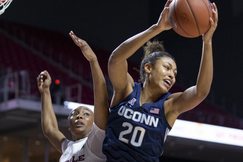 Connecticut forward Olivia Nelson-Ododa, right, grabs a rebound away from Temple forward Alexa Williamson, left, during the first half of an NCAA college basketball game Sunday, Nov. 17, 2019, in Philadelphia. (AP Photo/Laurence Kesterson)