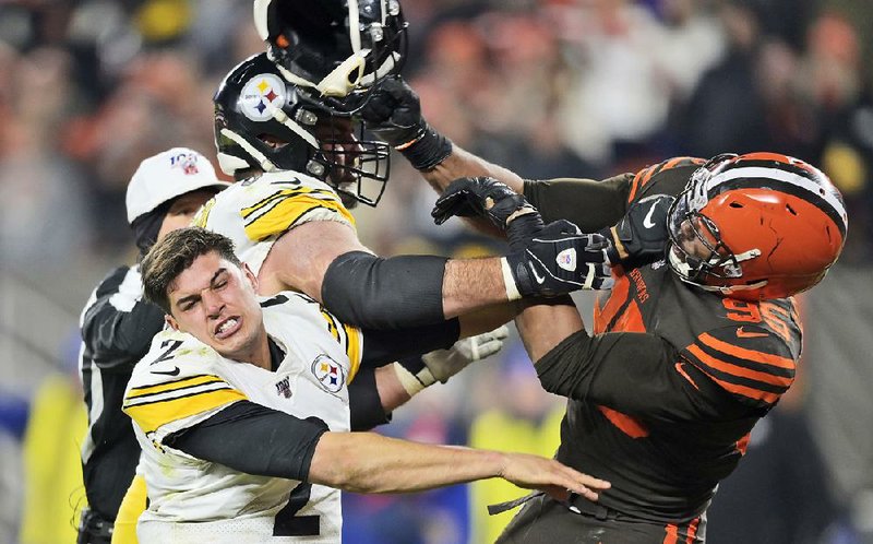 The Cleveland Browns began preparing for Sunday’s game against Miami without defensive end Myles Garrett (right), who will make his case to the NFL to have his indefinite suspension reduced Wednesday after last week’s incident in which he struck Pittsburgh quarterback Mason Rudolph (bottom left) in the head with a helmet during Thursday’s game in Cleveland.