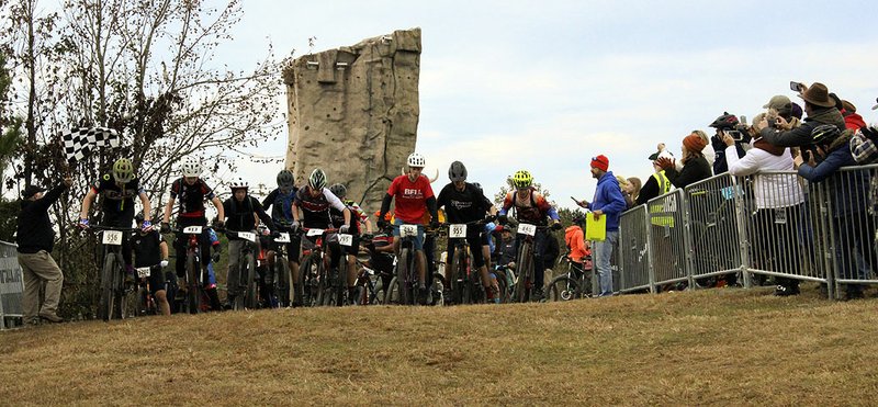 Riders pedal out from the starting line at Sunday morning's annual Attila the Hun XC Mountain Bike Race at Cedar Glades Park. - Photo by Jami Smith of The Sentinel-Record