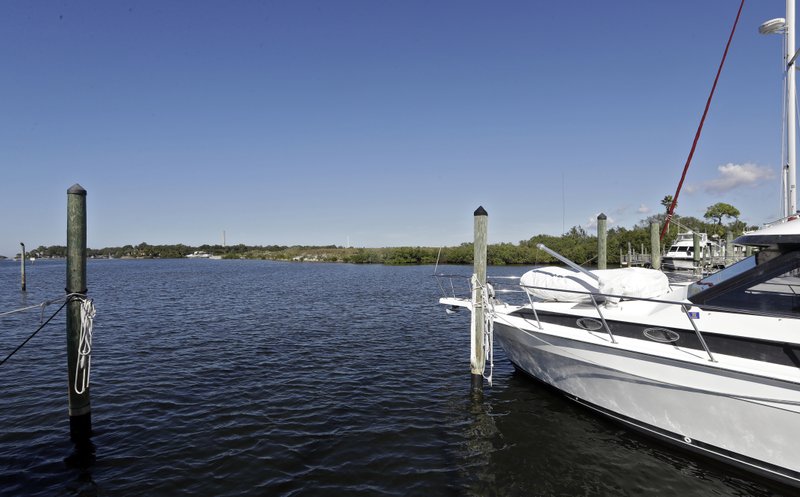 FILE - In this Nov. 30, 2017 photo, boats are shown moored in the Anclote River near the old Stauffer chemical plant site in Tarpon Springs, Fla. Hundreds of the nation's most polluted places are at an increasing risk of spreading contamination beyond their borders by more frequent storms and rising seas. Sixty percent of U.S. Superfund sites are in danger from weather extremes like hurricanes or wildfires, and the Trump administration&#x2019;s reluctance to acknowledge and plan for climate change is hurting chances of safeguarding them, according to a government watchdog. (AP Photo/Chris O'Meara, File)