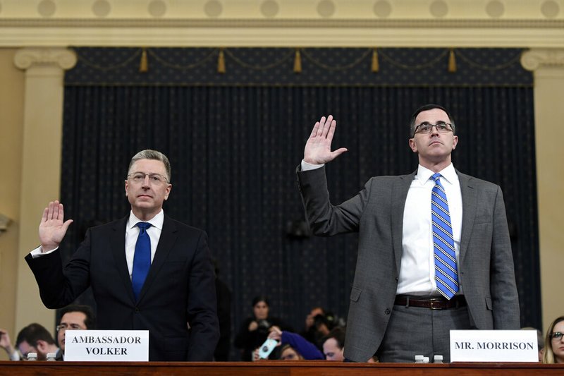 Ambassador Kurt Volker, left, former special envoy to Ukraine, and Tim Morrison, a former official at the National Security Council are sworn in to testify before the House Intelligence Committee on Capitol Hill in Washington, Tuesday, Nov. 19, 2019, during a public impeachment hearing of President Donald Trump's efforts to tie U.S. aid for Ukraine to investigations of his political opponents. (AP Photo/Susan Walsh)