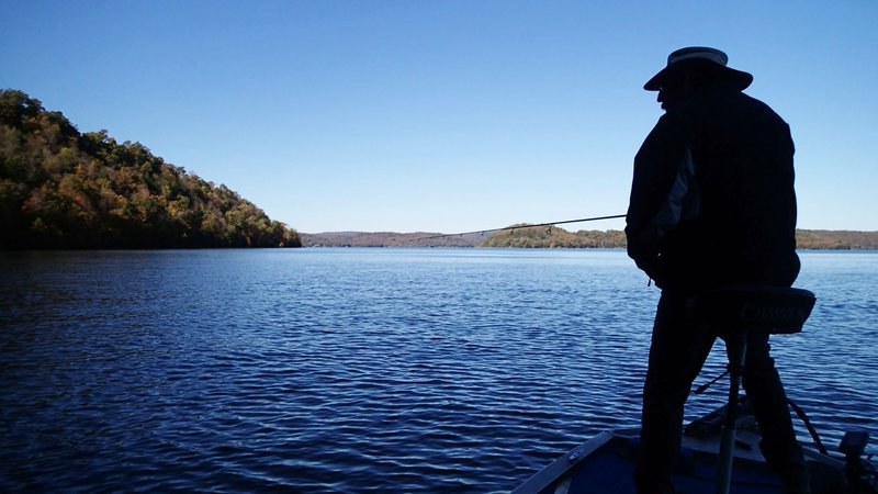 Dwayne Culmer fishes along a bluff in late afternoon on Nov. 1 2019 in the Rocky Branch area of Beaver Lake. A drop in water temperature vastly improved Culmer's catch rate for black bass compared to summer.