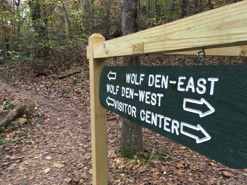 Signs direct riders around the Wolf Den Loop of the Monument Trail at Hobbs State Park-Conservation Area.
