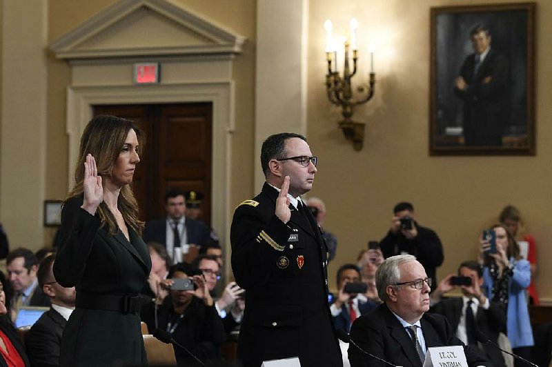 Jennifer Williams, an aide to Vice President Mike Pence, and Lt. Col. Alexander Vindman are sworn in Tuesday to testify in the impeachment inquiry. Vindman defended his loyalty to the U.S. while voicing concerns on Ukraine policy. More photos at arkansasonline.com/1120hearing/ 