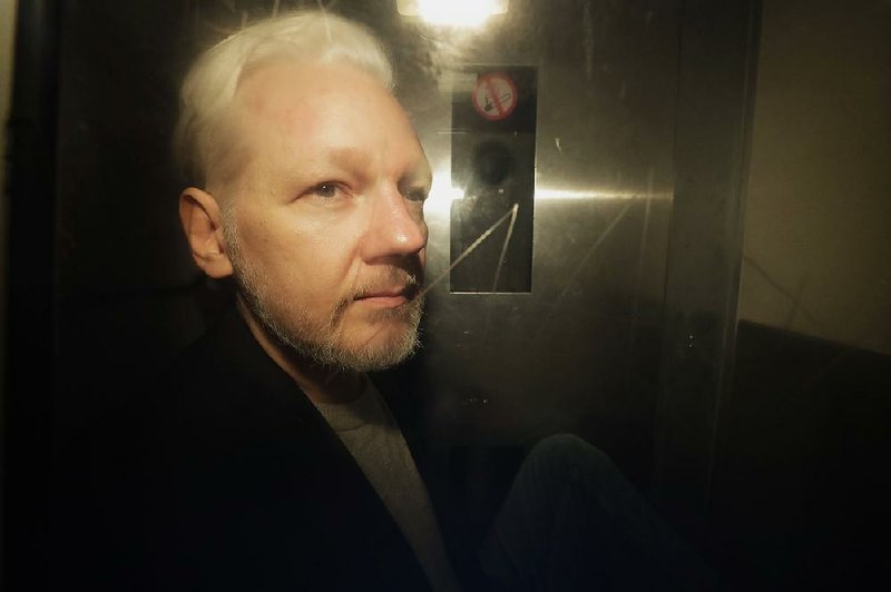  In this Wednesday May 1, 2019 file photo, WikiLeaks founder Julian Assange is taken from court, where he appeared on charges of jumping British bail seven years ago, in London.