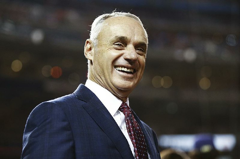 MLB commissioner Rob Manfred smiles at batting practice before Game 4 of the baseball World Series between the Houston Astros and the Washington Nationals Saturday, Oct. 26, 2019, in Washington. 