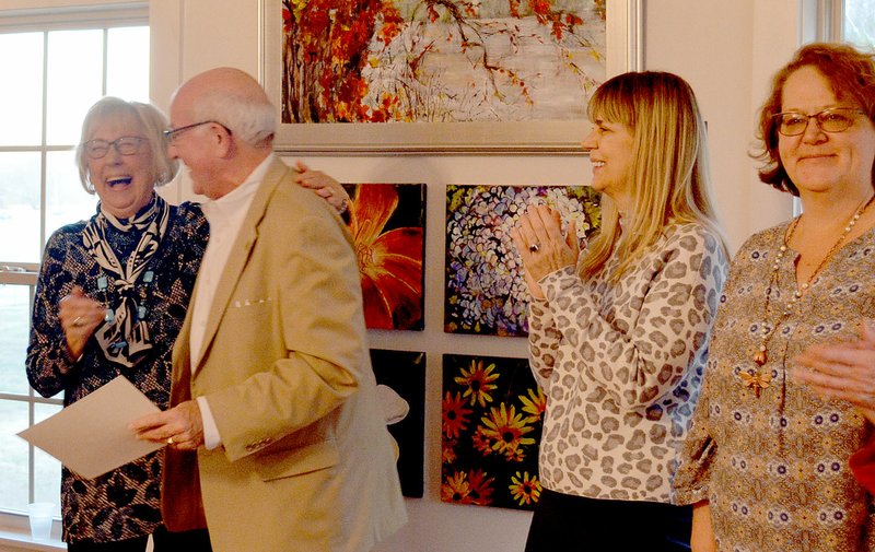 Keith Bryant/The Weekly Vista Carol Carlson (left) laughs and grins as Mayor Peter Christie presents the artist of the month certificate. Arts council member Demara Titzer and selection committee member Sara Parnell stand to the right.