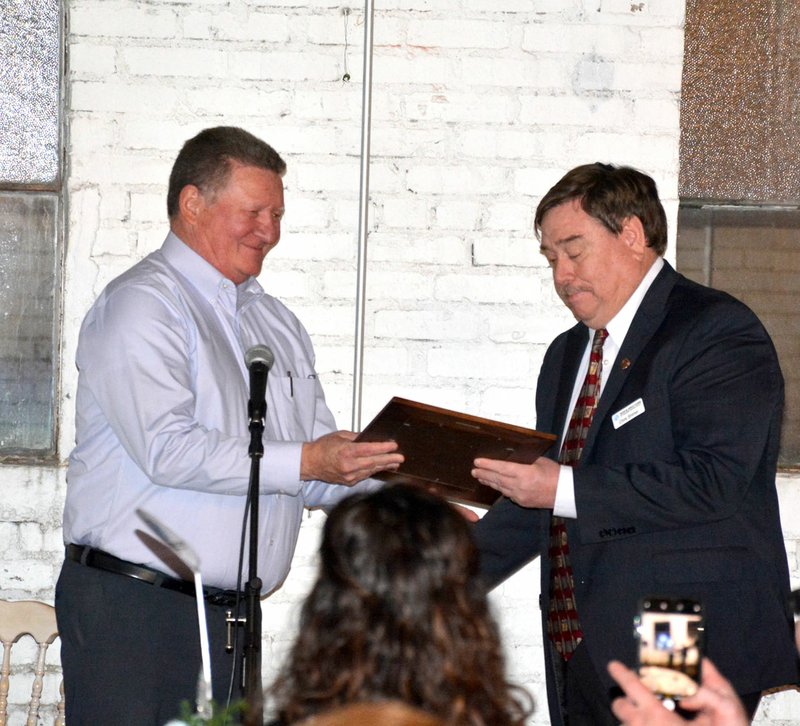 Marc Hayot/Herald Leader Tim McCord (left), accepts the Champion of Youth Award from Chris Shimer, chief professional officer for the Boys &amp; Girls Club of Western Benton County, at the Bill Foreman Hall of Fame Banquet on Nov. 14.