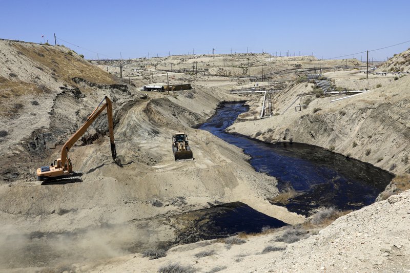  In this July 24, 2019, file photo, a crew works on seepage of 800,000 gallons of oil and brine water oil from an abandoned well in Chevron Corp's Cymric Oil Field in McKittrick, Calif. Gov. Gavin Newsom's administration has temporarily banned new oil wells in California if they use an extraction method that is linked to an ongoing oil spill in Kern County. (Irfan Khan/Los Angeles Times via AP, Pool, File)