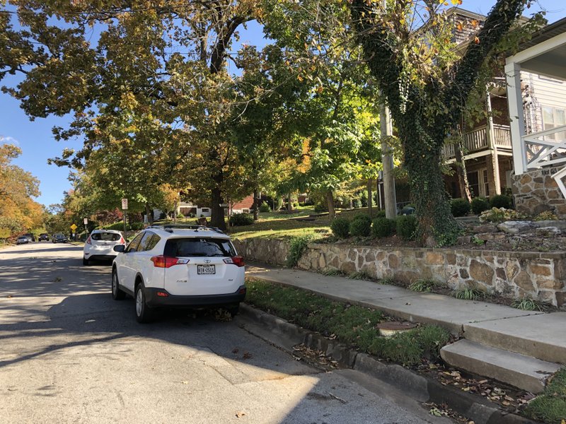 File photo/NWA Democrat-Gazette/STACY RYBURN A car bearing the Kappa Delta sorority insignia is parked Nov. 5 on Ila Street near Shady Avenue, south of Wilson Park in Fayetteville. The city held a public meeting to go over possible solutions to a crowded parking situation between neighbors and university students.