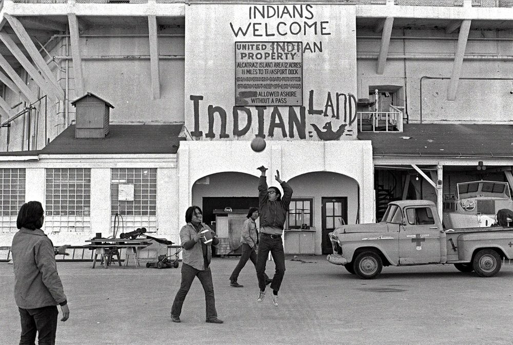 In this Nov. 26, 1969, file photo, Native Americans play ball games at the main dock area on Alcatraz in San Francisco during their occupation of the island. The week of Nov. 18, 2019, marks 50 years since the beginning of a months-long Native American occupation at Alcatraz Island in the San Francisco Bay. The demonstration by dozens of tribal members had lasting effects for tribes, raising awareness of life on and off reservations, galvanizing activists and spurring a shift in federal policy toward self-determination. (AP Photo/File)